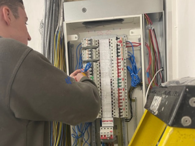 Mark Macnab working on a commercial electrical cabinet